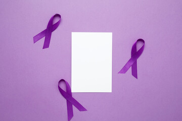 Purple Epilepsy Awareness Day, purple ribbon held, symbol of support. Mock up notebook