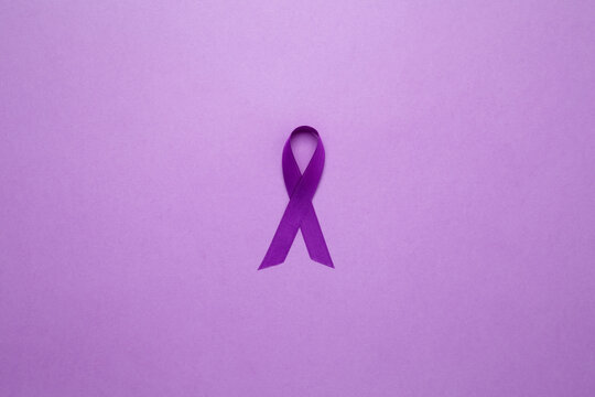 Purple Epilepsy Awareness Day, purple ribbon held, symbol of support