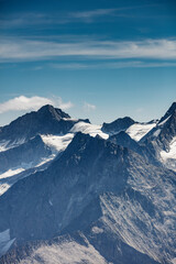 Obraz premium Majestic view of the Hintertux Glacier with rugged mountain peaks and clear blue skies in Austria's Tyrol region