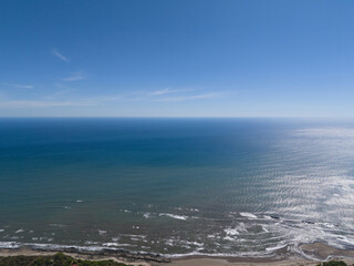 Expansive ocean view from high vantage point during clear sunny day