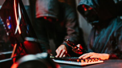 Hooded Hacker coding destroy online data system with virus ransomware in server..