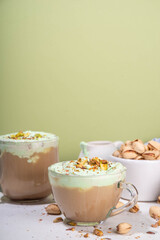 Vegan pistachio milk coffee latte. Iced and hot coffee drinks with plant based whipped pistachio creamer, copy space