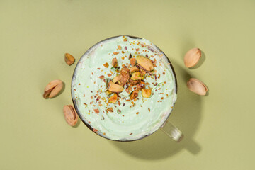 Vegan pistachio milk coffee latte. Iced and hot coffee drinks with plant based whipped pistachio creamer, copy space