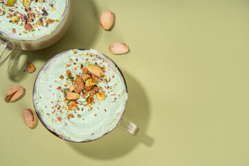 Vegan pistachio milk coffee latte. Iced and hot coffee drinks with plant based whipped pistachio creamer, copy space