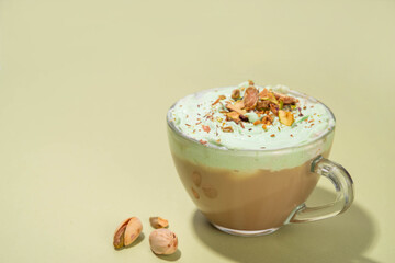 Vegan pistachio milk coffee latte. Iced and hot coffee drinks with plant based whipped pistachio creamer, copy space