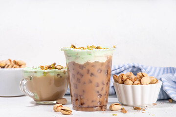 Vegan pistachio milk coffee latte. Iced and hot coffee drinks with plant based whipped pistachio creamer, copy space