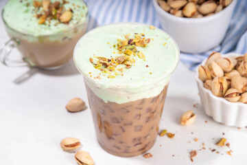 Vegan pistachio milk coffee latte. Iced and hot coffee drinks with plant based whipped pistachio creamer, copy space