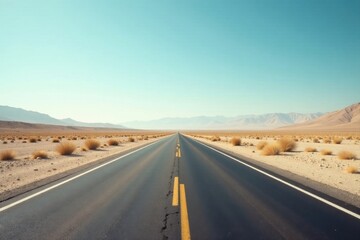 Endless Asphalt Ribbon Unfurling Through Arid Landscape Under a Vast, Clear Sky