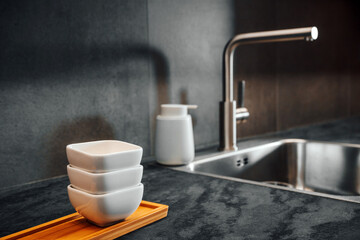 Kitchen counter top with serving pots and water faucet and sink