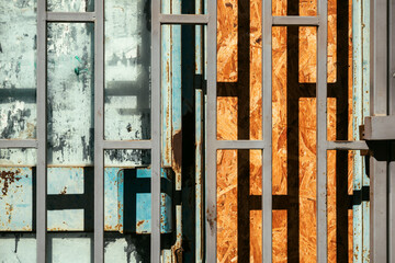 Shopwindow protective security bars on old abandoned store