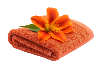 A vibrant orange towel adorned with a beautiful flower, perfect for spa or home decor settings, evoking relaxation and tranquility.
