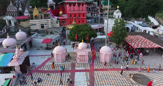 A stunning aerial view showcasing the serene Jawalamukhi Temple complex in Himachal Pradesh, with its campus, main shrine, and surrounding hills bathed in natural light.
