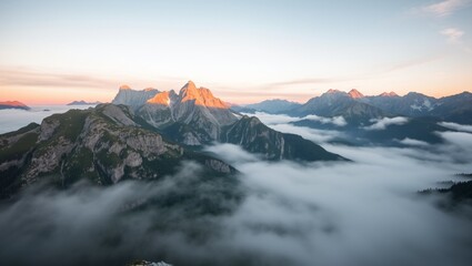 A stock photo of a breathtaking misty mountain range at dawn.