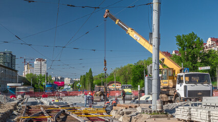 Loader crane for loading and unloading concrete plates on a road construction site timelapse
