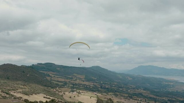 Paragliding hobby flying above the clouds enjoying leisure time couple gift experience extraordinary