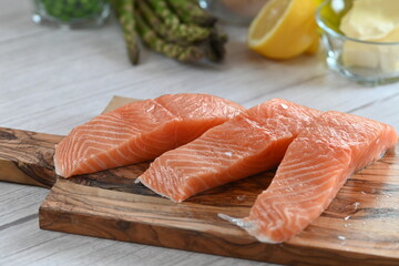 High-quality raw salmon fillet with a vibrant orange hue, beautifully arranged on a light background