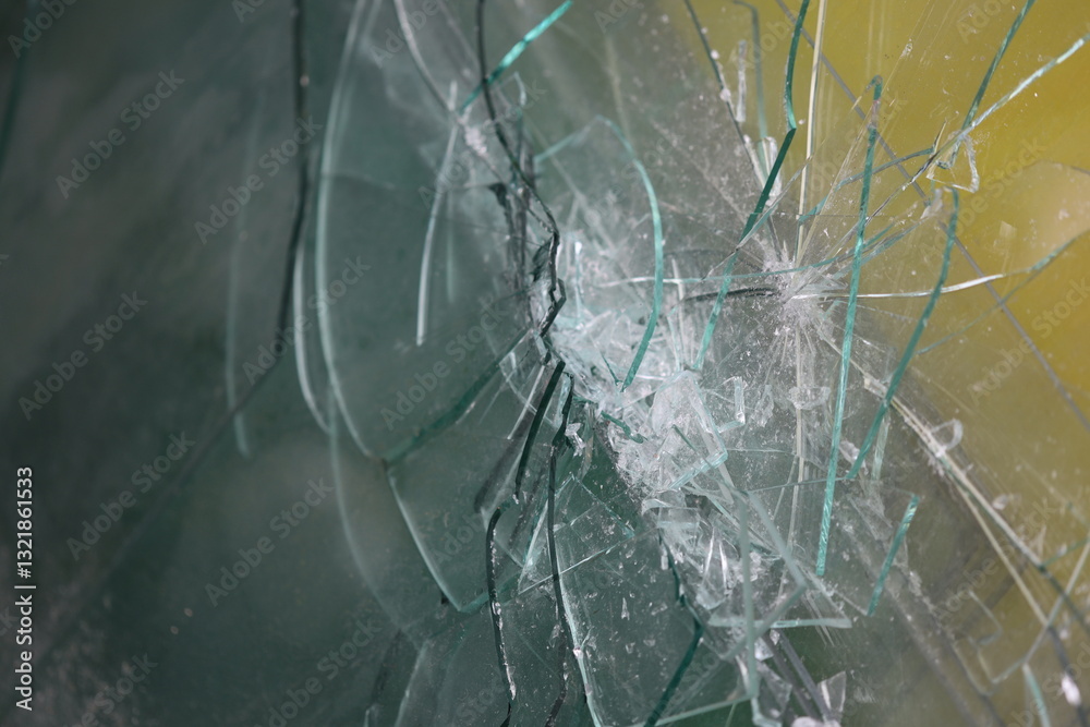 Poster a close-up view of a broken glass window on a bright yellow background.