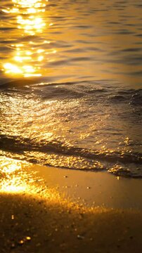 Gentle waves lapping at the shore, accompanied by the sounds of people enjoying their time by the beach