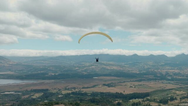 Paragliding hobby flying above the clouds enjoying leisure time couple gift experience extraordinary