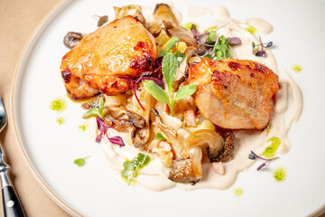 Grilled chicken atop creamy sauce, surrounded by vibrant vegetables enhances the dish
