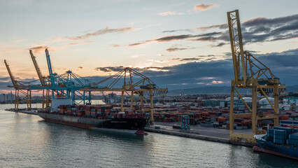 Fototapeta premium Aerial view of the sea cargo port and container terminal of Barcelona timelapse, Barcelona, Catalonia, Spain.