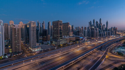 Dubai Marina skyscrapers aerial top view before sunrise from JLT in Dubai night to day timelapse, UAE.