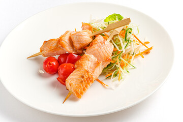 Savory salmon skewers paired with crisp salad and vibrant cherry tomatoes create a delightful feast