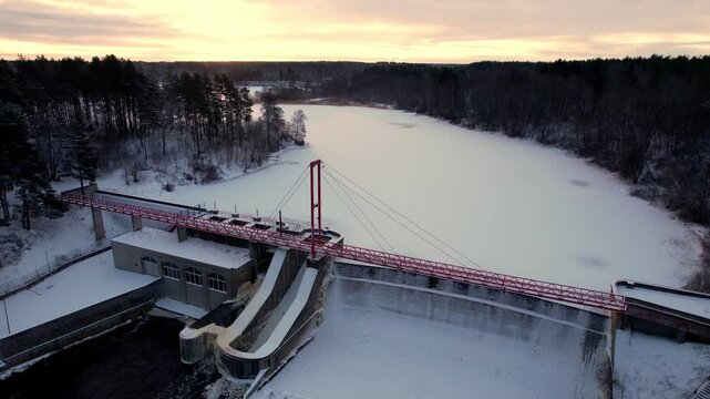 aerial view of hydroelectric dam on winter river