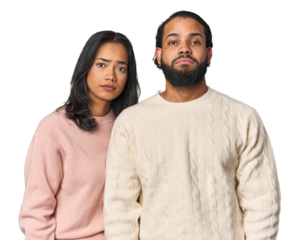 Young Latino couple in studio sad, serious face, feeling miserable and displeased.