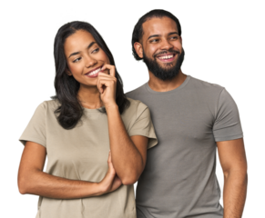 Young Latino couple in studio relaxed thinking about something looking at a copy space.