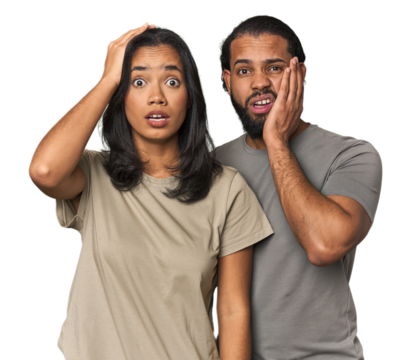 Young Latino couple in studio being shocked, she has remembered important meeting.