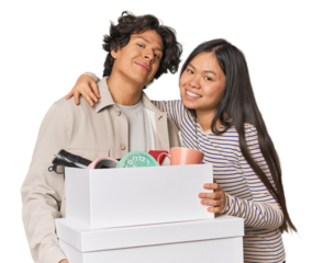 Multiracial young couple with moving boxes in studio