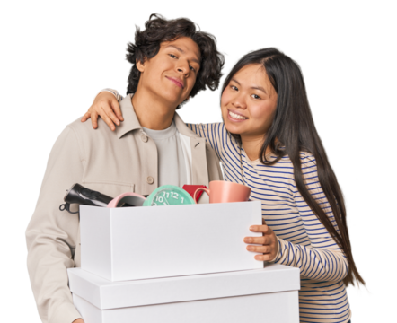 Multiracial young couple with moving boxes in studio