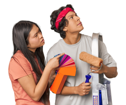 Happy multiracial couple with painting tools in studio