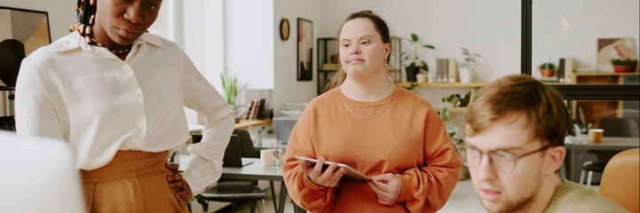 Website banner with biracial concentrated colleague working on new application together in office