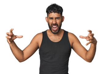 Young Hispanic man isolated screaming with rage.