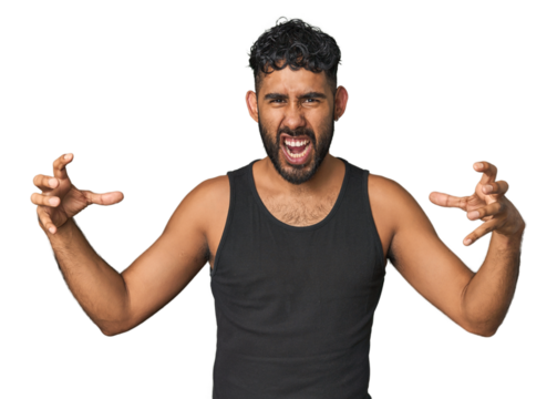 Young Hispanic man isolated screaming with rage.