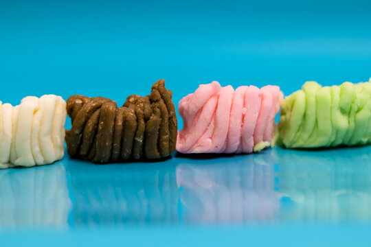 Colorful Kueh Sepit Indonesian Crispy Egg Rolls on a Shiny Blue Surface