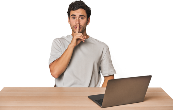 Hispanic young man working on laptop keeping a secret or asking for silence.