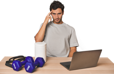 Hispanic trainer planning workout pointing temple with finger, thinking, focused on a task.