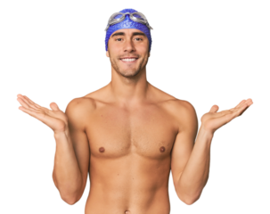 Young Hispanic man with swim gear makes scale with arms, feels happy and confident.