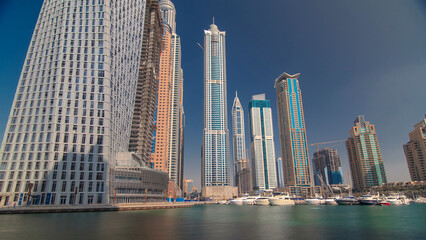 Obraz premium Dubai Marina with tallest skyscrapers and boats timelapse hyperlapse