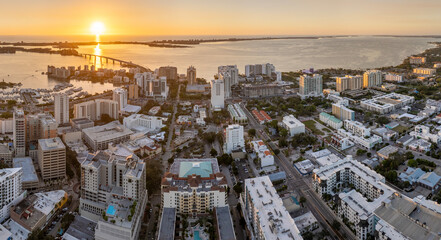Aerial view of Sarasota city downtown at sunset with high-rise office buildings and Ringling Bridge on horizon. Real estate development in Florida. USA travel destination © bilanol