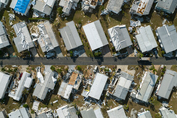 Destroyed by strong hurricane winds suburban houses in Florida mobile home residential area....
