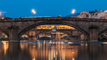 Naklejka premium Ponte Alla Carraia and Santa Trinita Holy Trinity Bridge day to night timelapse over River Arno in Florence
