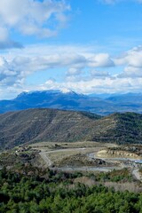 Aerial view from summit on Pyrenees mountain range. Early spring, vivid cloudscape