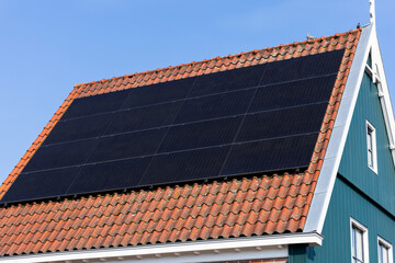 Solar Panels on a Traditional Dutch House with Red Tile Roof