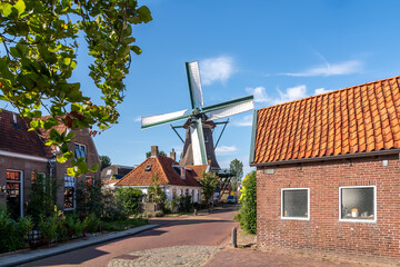 A classic Dutch windmill in the charming village of Woudsend, Friesland, Netherlands.