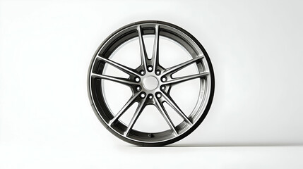 Obraz premium Close-Up Studio Shot of a Modern Silver Alloy Wheel with Multiple Spokes on a White Background