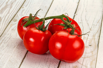 Ripe fresh tomato on the branch